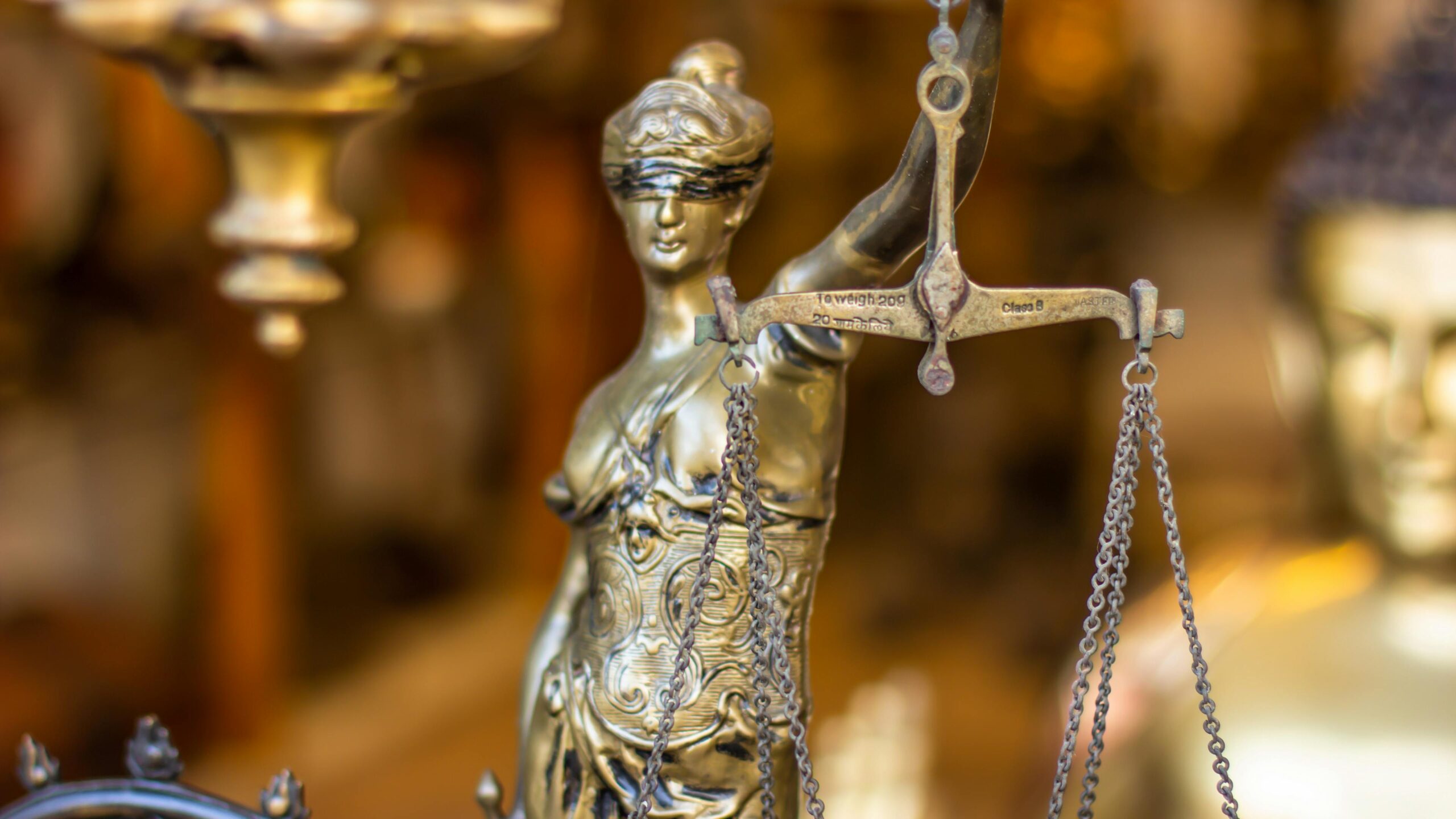 A detailed close-up of a Lady Justice statue holding scales, symbolizing law and justice.